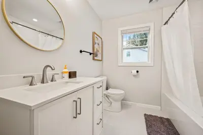 a bathroom with a sink and a toilet and a mirror at Old, Unlisted in Bloomfield