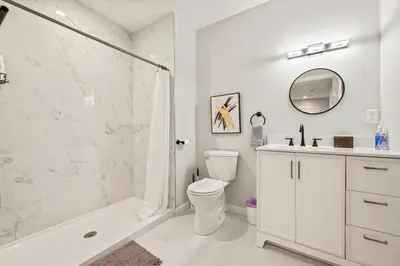 a white bathroom with a toilet and a shower at Old, Unlisted in Bloomfield