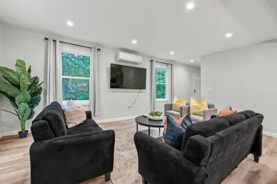a living room with two couches and a tv at Old, Unlisted in Bloomfield