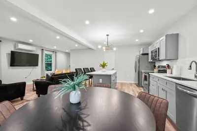 a kitchen and living room with a table and chairs at Luxury 5BR Home in Central Bloomfield Spot in Bloomfield