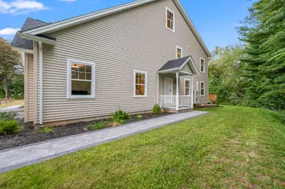 a white house with a lawn in front of it at Luxury 5BR Home in Central Bloomfield Spot in Bloomfield