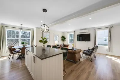 a kitchen and living room with a table and chairs at Elegant 2 Story Bloomfield 3 Kings 2 Queens in Bloomfield