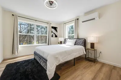 a white bedroom with a bed and two windows at Elegant 2 Story Bloomfield 3 Kings 2 Queens in Bloomfield