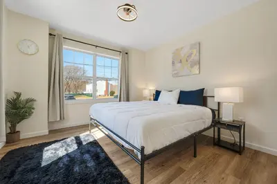 a bedroom with a large bed and a window at Elegant 2 Story Bloomfield 3 Kings 2 Queens in Bloomfield