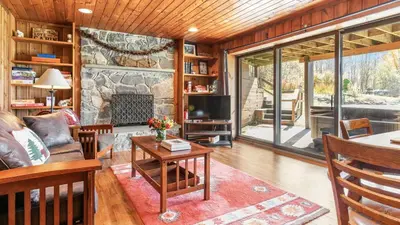 a living room with a stone fireplace in a house at Discounted Winter Rates Ski Retreat Hot Tub Fire Pit Windham Mountain House in Windham