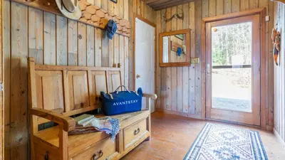 a room with a wooden wall with a wooden door at Discounted Winter Rates Ski Retreat Hot Tub Fire Pit Windham Mountain House in Windham
