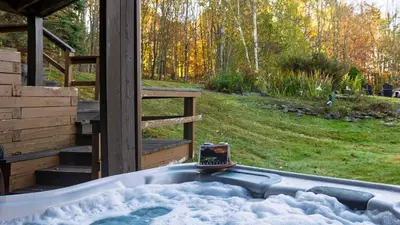a bath tub with a cell phone sitting on top of it at Discounted Winter Rates Ski Retreat Hot Tub Fire Pit Windham Mountain House in Windham