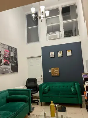 a living room with green couches and a red bus at Hidden Gem BK in Brooklyn