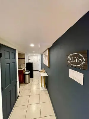 a hallway leading to a kitchen with a blue wall at Hidden Gem BK in Brooklyn