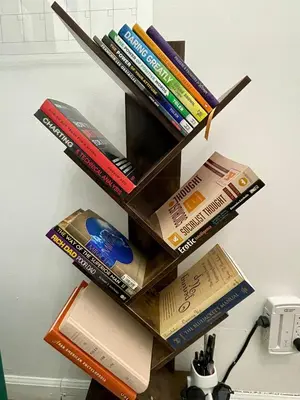 a book shelf filled with books on a wall at Hidden Gem BK in Brooklyn