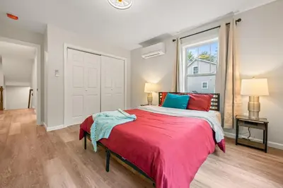 a bedroom with a large bed and a window at Spacious House with King Beds in Prime Location in Bloomfield