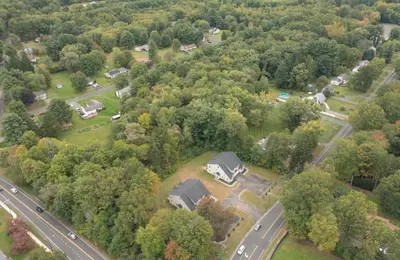 an aerial view of a house with a road and trees at Spacious House with King Beds in Prime Location in Bloomfield