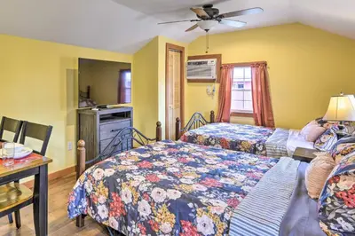 a bedroom with two beds and a table with a desk at Deluxe Duplex close to Ski Runs in Pleasant Mount