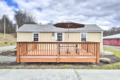 a house with an umbrella on a wooden deck at Deluxe Duplex close to Ski Runs in Pleasant Mount