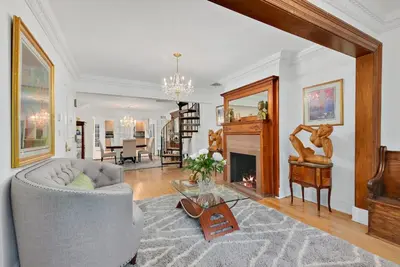 a living room with a couch and a fireplace at Harlem Gem in New York