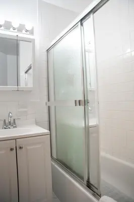 a bathroom with a shower and a sink at Harlem Muse in New York