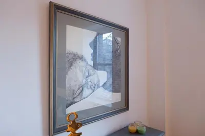 a framed picture on a wall above a table at Historic Striver's Row Apartment in New York