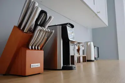 a group of knives are lined up on a table at Cozy Home, 19m to NYC, 10m to American Dream in Wallington