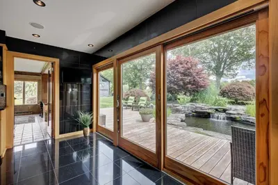 a large room with a deck and a pond at Longpond House in Salisbury