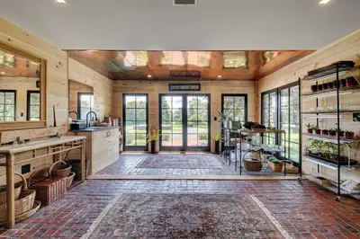 a large kitchen with wooden walls and windows at Longpond House in Salisbury