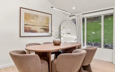 a dining room with a wooden table and chairs at Pond House at Carter Bridge Estate in Freehold