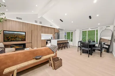 a living room with a fireplace and a dining room at Pond House at Carter Bridge Estate in Freehold