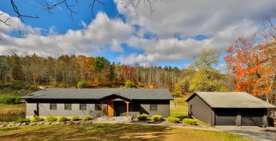 a house in the middle of a field at Hot Tub Pool & Pond - Catskills Family Escape in Cairo