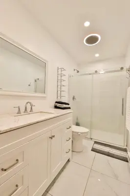 a bathroom with a sink and a toilet and a mirror at Hot Tub Pool & Pond - Catskills Family Escape in Cairo
