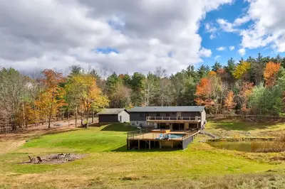 an aerial view of a house on a hill with a pond at Hot Tub Pool & Pond - Catskills Family Escape in Cairo