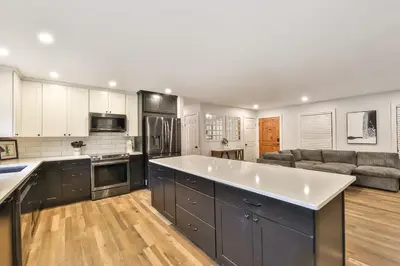 a kitchen with a large white counter top and a couch at Hot Tub Pool & Pond - Catskills Family Escape in Cairo