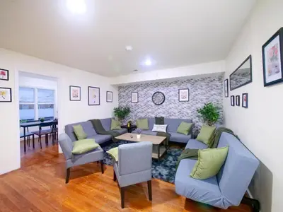 a living room with blue couches and a table at Charming Private Room in a Friendly Home mins to NYC in Jersey City