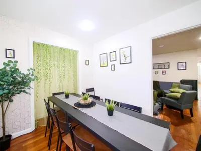 a living room with a table and chairs and a couch at Private Bedroom with Shared Amenities mins to NYC in Jersey City