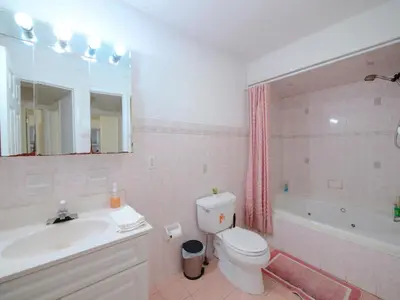 a bathroom with a sink and a toilet and a tub at Private Bedroom with Shared Amenities mins to NYC in Jersey City