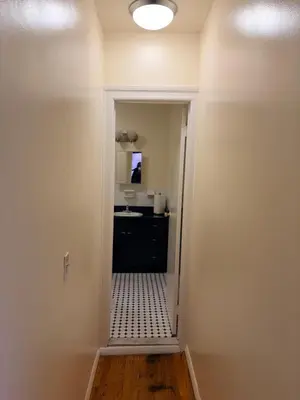 a hallway with a door leading into a bathroom at The Park Ave Studio in New York