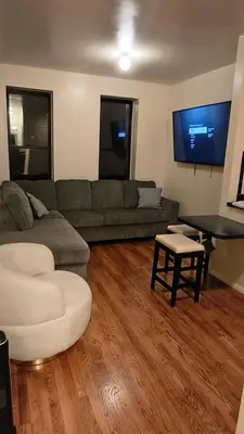 a living room with a couch and a table at The Park Ave Studio in New York