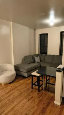 a living room with a couch and a table at The Park Ave Studio in New York