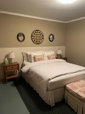 a bedroom with a large bed and two night stands at The Mountain Brook Inn in Bovina Center