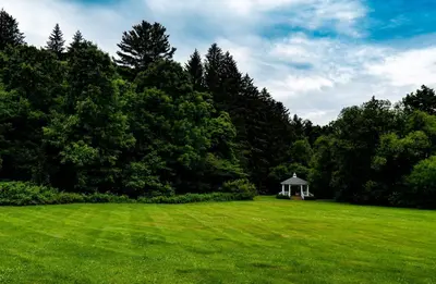 a gazebo in the middle of a grass field at The Mountain Brook Inn in Bovina Center