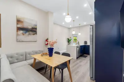 a living room with a couch and a table at Elegant Home w Patio | In-Unit Laundry Near NYC in Jersey City