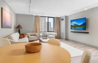 a living room with a table and chairs and a tv at Hartford New 1BR near XL Center and Convention in Hartford