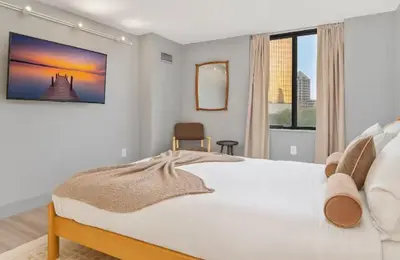 a bedroom with a large white bed and a window at Hartford New 1BR near XL Center and Convention in Hartford
