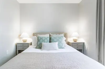a bedroom with a white bed with blue pillows at Downtown 2BR Gem Yale Wooster Sq WiFi in New Haven
