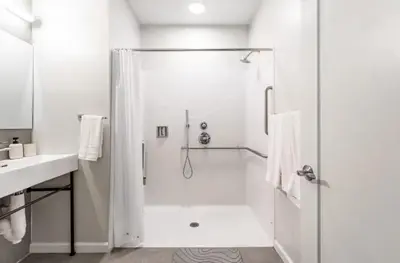 a white bathroom with a shower and a sink at Downtown 2BR Gem Yale Wooster Sq WiFi in New Haven