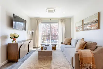 a living room with a couch and a tv at Downtown 2BR Gem Yale Wooster Sq WiFi in New Haven