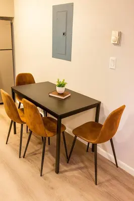 a black table with chairs and a plant on it at Modern 2BR Westville Downtown Near Yale Wifi in New Haven