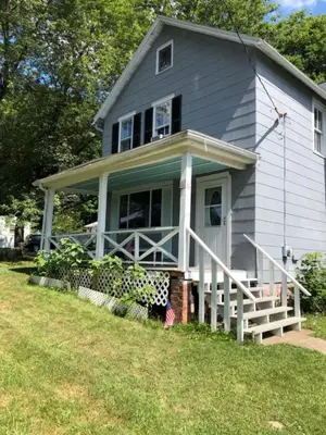 a gray house with a porch and a yard at New Leeds listing Near Graces diner and Hudson! in Catskill