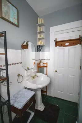 a bathroom with a white sink and a mirror at Cozy Apartment in Artsy Westville New Haven in New Haven