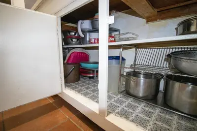 a kitchen with pots and pans on the shelves at Cozy Apartment in Artsy Westville New Haven in New Haven