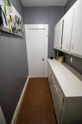 a kitchen with white cabinets and a white door at Cozy Apartment in Artsy Westville New Haven in New Haven