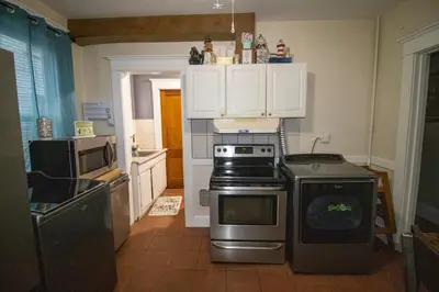 a kitchen with a stove and a microwave at Cozy Apartment in Artsy Westville New Haven in New Haven